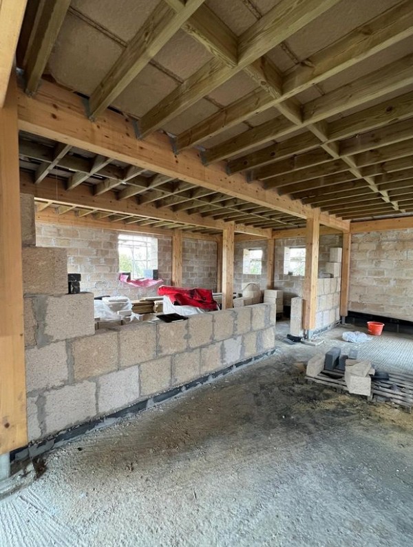 Internal hempcrete block walls being built in the glulam framce